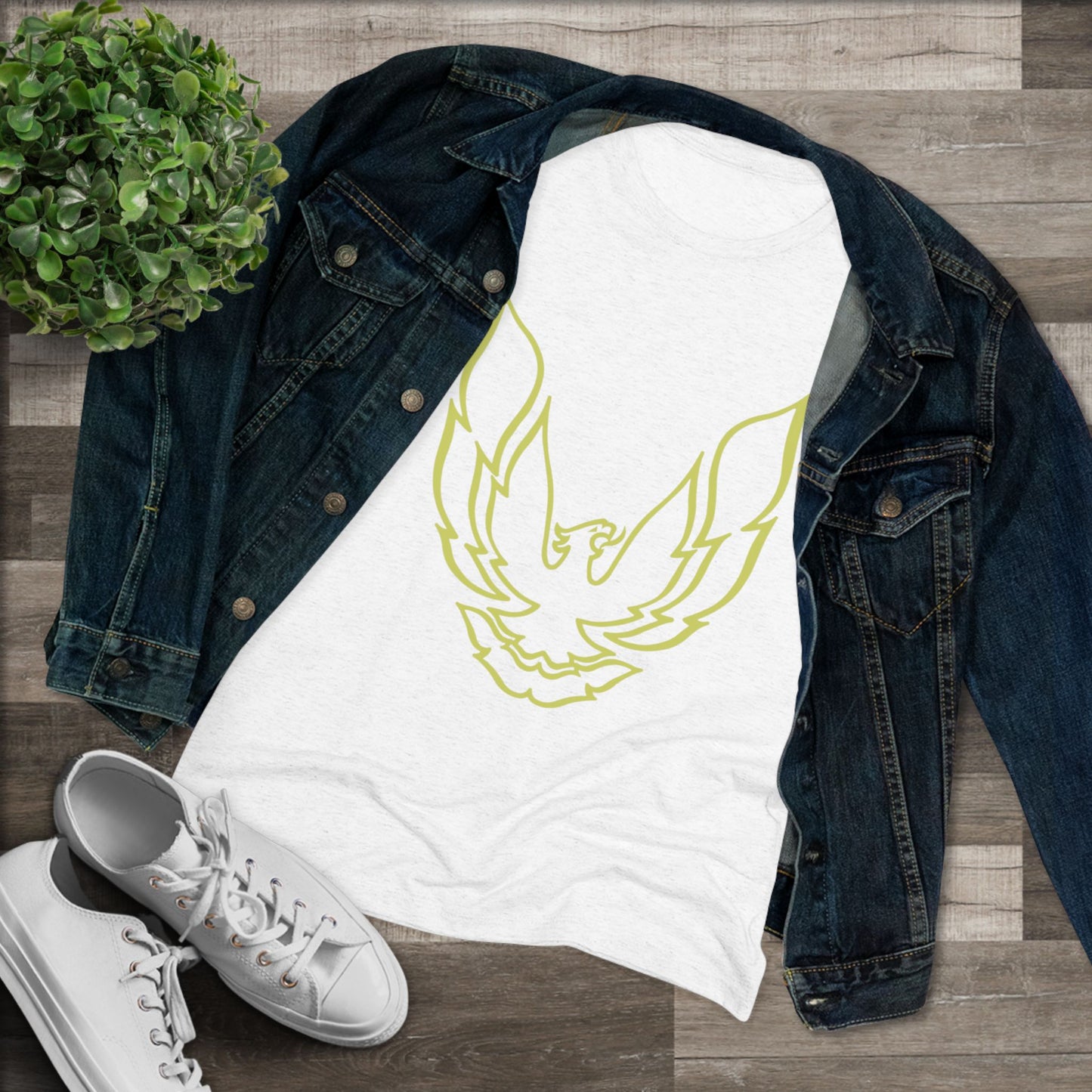 A retro 1970's-inspired red women's triblend tee by Printify, featuring a stylish gold phoenix design on the front. The vibrant, sleek graphic depicts the iconic Trans Am bird with its wings spread upward, giving this cozy t-shirt a bold and dynamic look.