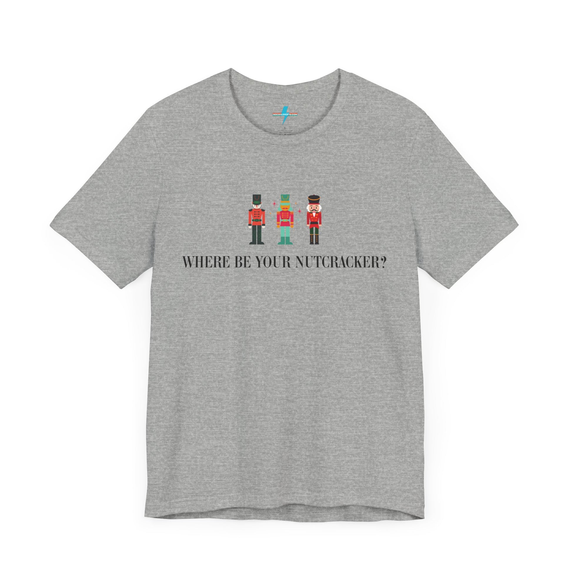 The Printify "Where Be Your Nutcracker? ITYSL T-Shirt" in light gray features three Nutcracker soldiers in festive uniforms, with the text "WHERE BE YOUR NUTCRACKER?" printed in black below the soldiers, making it a perfect holiday shirt.