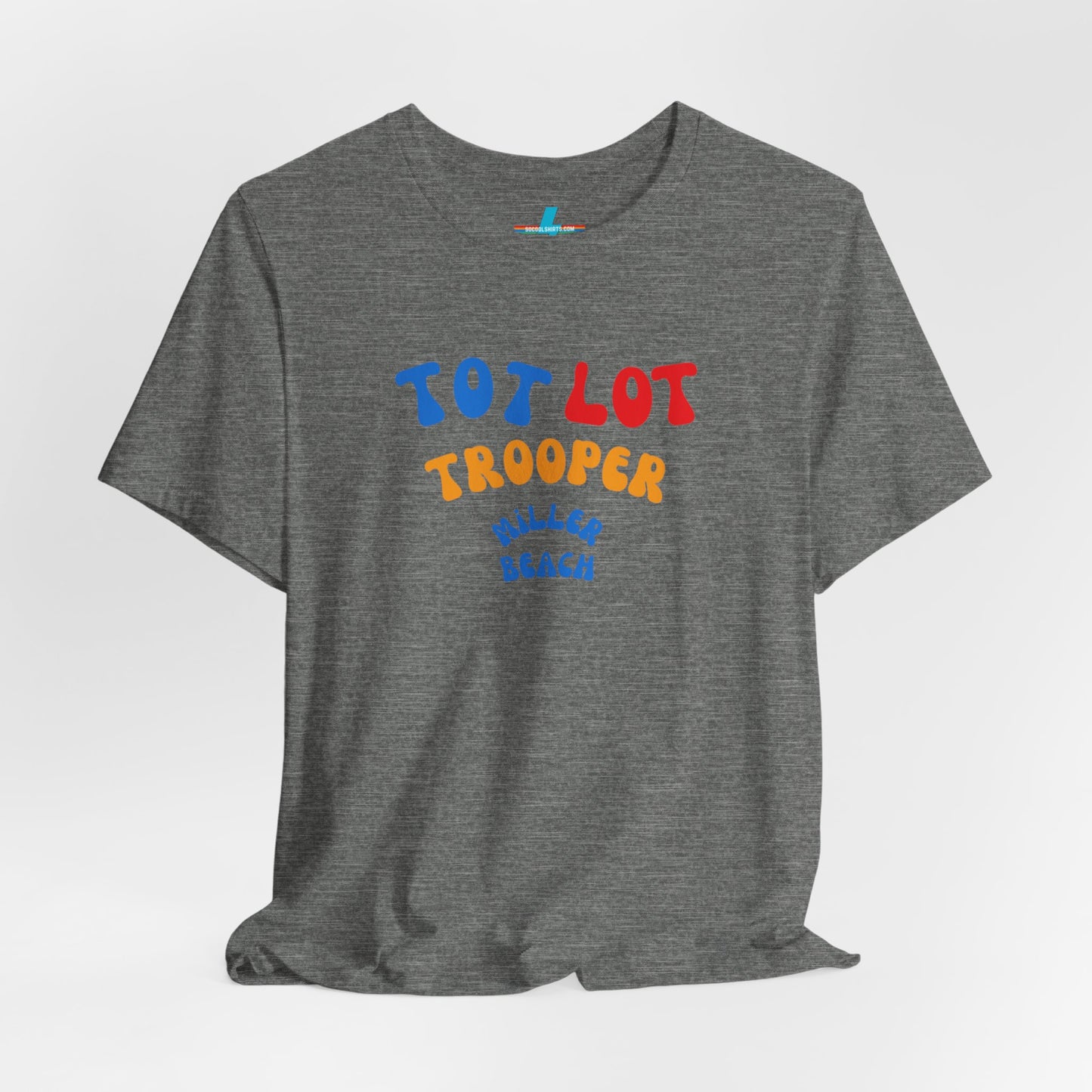 A green unisex jersey short sleeve tee from Printify, featuring colorful text on the front that reads "TOT LOT TROOPER MILLER BEACH" in blue, red, yellow, and orange letters. The shirt is displayed against a plain white background.