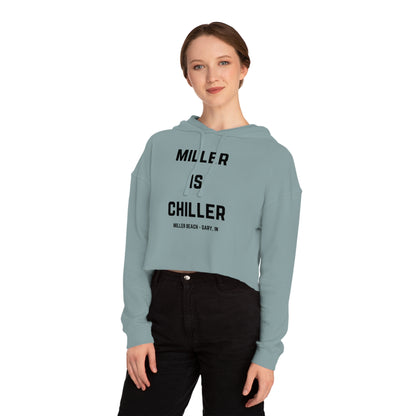 A white Women's Cropped Hooded Sweatshirt by Printify, featuring the phrase "MILLER IS CHILLER" printed in bold black letters on the front. Below the phrase, it says "MILLER BEACH • GARY, IN" in smaller black text. The SoCool Shirts hoodie includes a drawstring hood and long sleeves.