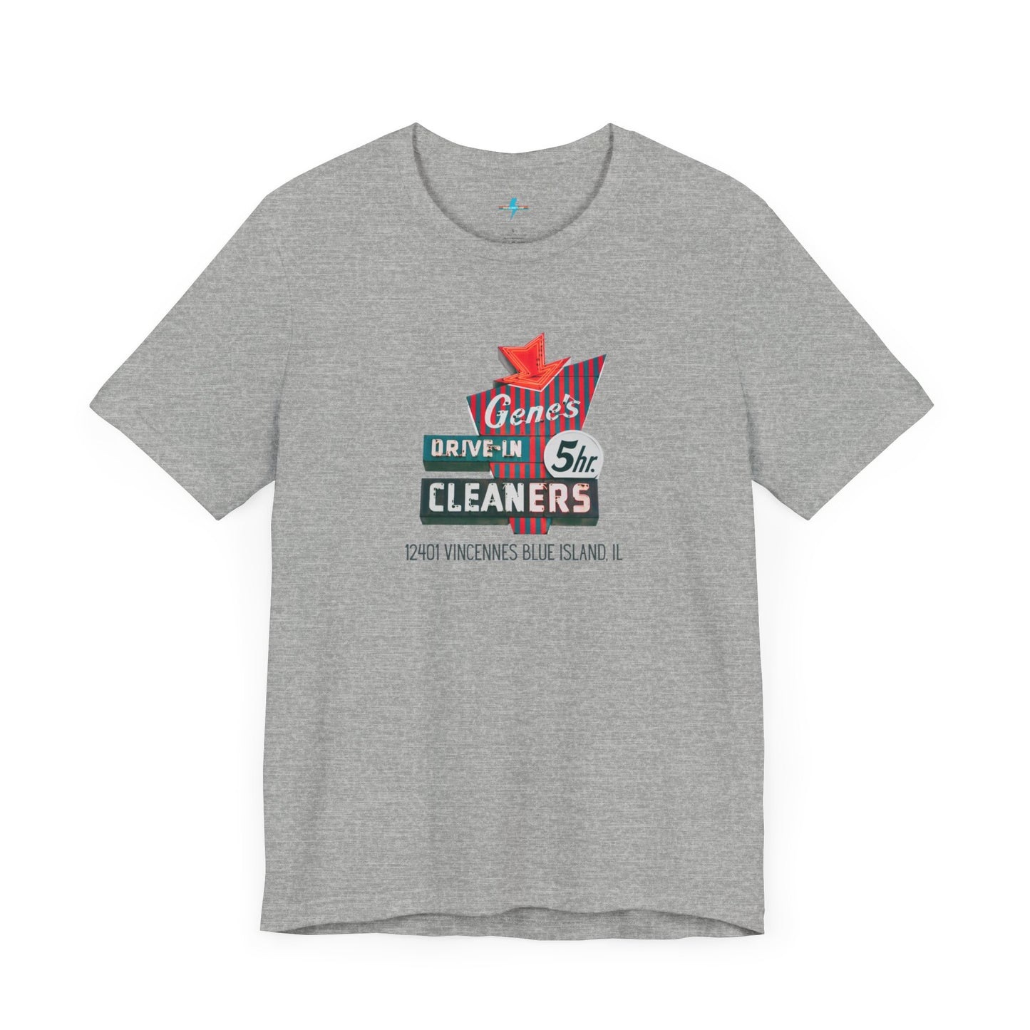 A unisex Jersey short sleeve tee from Printify featuring a light grey color with a retro-style graphic in the center. The design showcases text that reads "Gene's Drive In Cleaners, 5th," along with the address "12401 Vincennes Blue Island IL" in a blend of vintage fonts and colors, evoking the classic Chicago Fire-era vintage sign aesthetic.