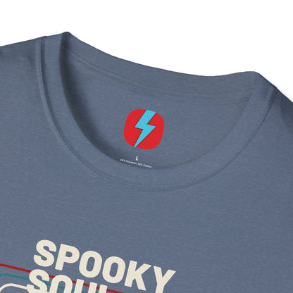 The Spooky Soul - Halloween - Unisex Softstyle T-Shirt by Printify, available in dark gray, showcases a retro-style graphic of a mummy dancing with two kids in Halloween costumes. The text "SPOOKY SOUL" is displayed above the image, which is framed by red and blue lines to enhance its vintage feel.