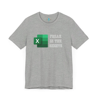 A green Freak in the Sheets - Excel - Unisex Jersey Short Sleeve Tee from Printify, featuring the Microsoft Excel logo on the left. The text next to the logo reads, "FREAK IN THE SHEETS" in white, bold, all-caps letters, making it perfect for spreadsheet enthusiasts. The shirt is laid flat against a plain white background.