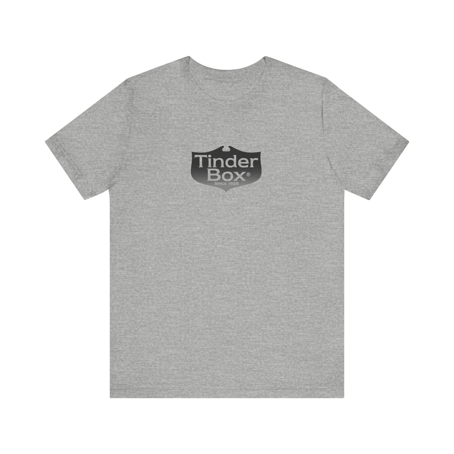 A light blue Printify "The Tinder Box 1980s" unisex jersey short sleeve tee featuring the "Tinder Box" logo in the center. The logo consists of a dark shield with the words "Tinder Box" in white text, with a small flame icon replacing the dot above the "i".