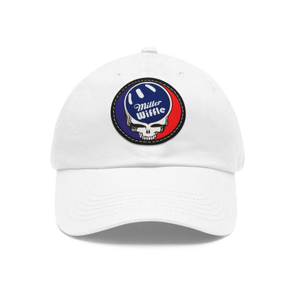 Product Description: The Dad Hat with Leather Patch (Round) - Miller Wiffle Grateful Dead Stealy by Printify is a red baseball cap made from bio-washed chino twill. It features a round PU leather patch on the front, depicting a blue and white wiffle ball above a stylized white skull. The words "Miller Wiffle" are written in white text on the ball. This cap includes a curved brim and ventilation holes on top for added comfort.