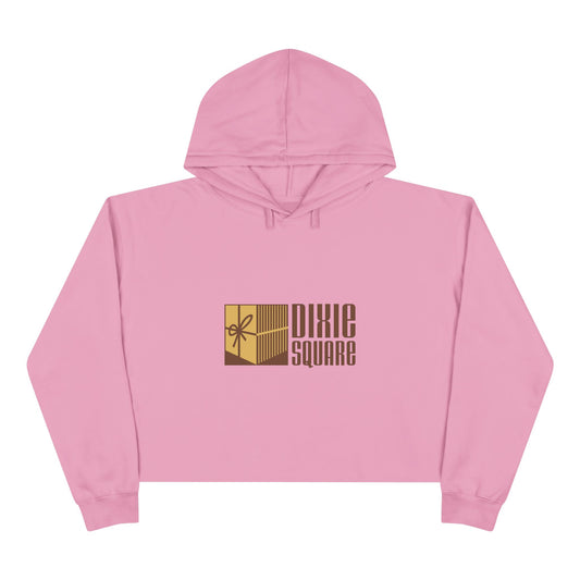 Pink cropped hoodie from Printify, showcasing a yellow and brown "Dixie Square" logo with a ribbon design on the front, reminiscent of the iconic Dixie Square Mall in Harvey, IL from the Blues Brothers era.