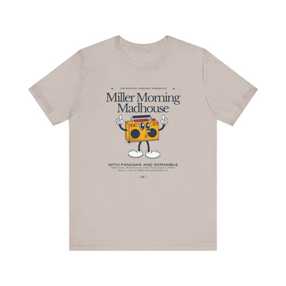 This Printify unisex jersey short sleeve tee in Sand Dune features a playful boombox cartoon character with arms, legs, and sunglasses. Emblazoned with "Miller Morning Madhouse," it highlights podcast details from "The School Podcast Presents.