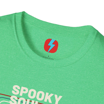 The Spooky Soul - Halloween - Unisex Softstyle T-Shirt by Printify, available in dark gray, showcases a retro-style graphic of a mummy dancing with two kids in Halloween costumes. The text "SPOOKY SOUL" is displayed above the image, which is framed by red and blue lines to enhance its vintage feel.