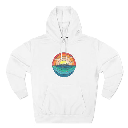 The Miller Beach Abstract - Three-Panel Fleece Hoodie by Printify is a premium light gray pullover featuring a vibrant circular front design. It showcases an abstract sunset-over-ocean scene with blue waters, an orange to red gradient sky, and a city skyline silhouette. Made from soft combed ring-spun cotton and lined with cozy fleece for extra warmth.