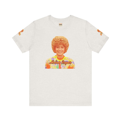 A lavender-colored Helen (Mrs.) Roper Three's Company - Unisex Jersey Short Sleeve Tee by Printify is hanging on a wooden hanger against a white background. This T-shirt features an image of a smiling person with curly hair wearing a colorful blouse, with the text "Helen Roper" underneath the image. Both sleeves have identical designs, making it perfect Three's Company merchandise.