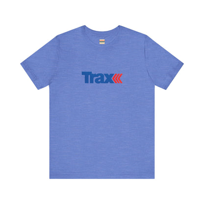 A gray unisex jersey short sleeve tee from Printify, inspired by retro 1980s Kmart style. The "Trax" logo is printed in blue letters, followed by three red arrows pointing to the right. This classic Trax Brand T-shirt is laid flat against a white background, capturing nostalgic fashion vibes.