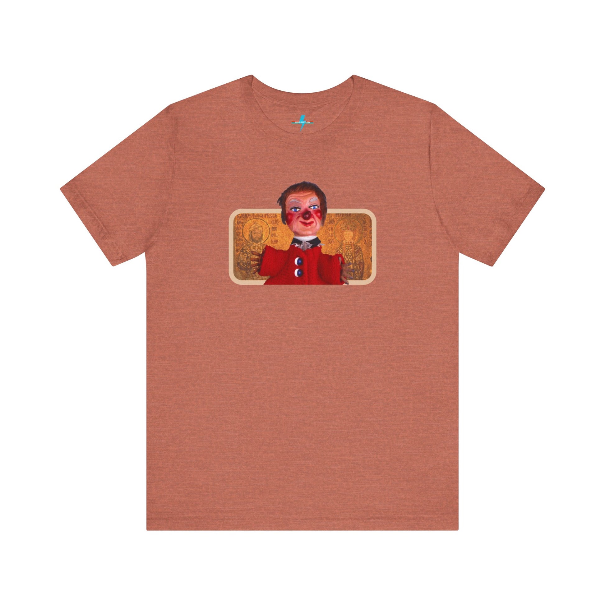 The rust-colored Printify Lady Elaine - Mr. Rogers Unisex Jersey Short Sleeve Tee features a detailed image of the Lady Elaine puppet, dressed in a red outfit with a painted face, set against an intricate artistic backdrop. The centrally positioned puppet and vivid colors create a striking contrast against the muted tone of the shirt, evoking nostalgic memories of Mr. Rogers' Neighborhood.