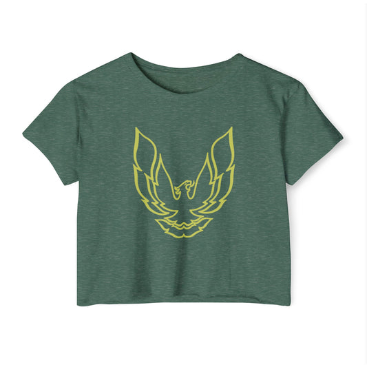 The Pontic Trans Am - Women's Festival Crop Top by Printify is a green heathered crop top featuring a large, stylized yellow eagle graphic with wings spread wide on the front, reminiscent of the Pontiac Phoenix Trans Am logo. With a simple crew neck and short sleeves, this top is ideal for vintage enthusiasts.