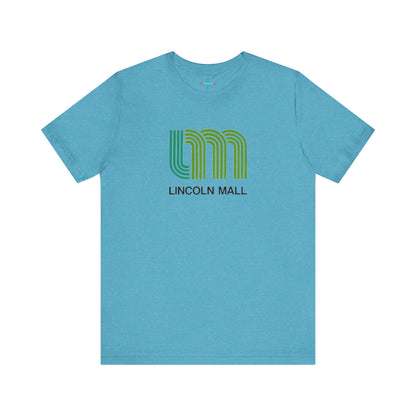 A light green unisex jersey short sleeve tee by Printify features "LINCOLN MALL" written under a retro-styled green and blue curved line design, celebrating the 70s and 80s shopping era in Lincoln Mall Matteson.