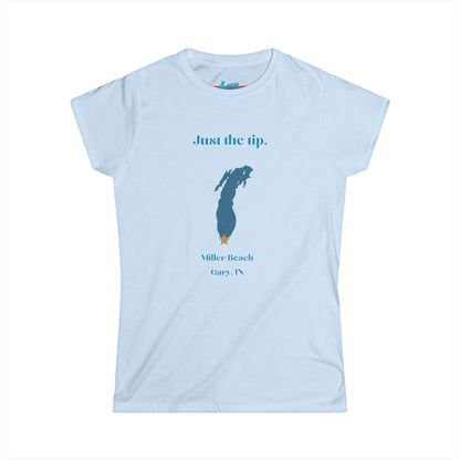 The Printify Just the Tip - Miller Beach Women's Softstyle Tee, crafted from high-quality tri-blend fabric, showcases a light blue color with a stylized wave graphic alongside the text "Just the tip. Miller Beach, Gary, IN." This tee is both casual and stylish, making it an ideal choice to express your beachside spirit.