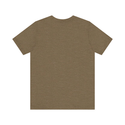 A light blue Printify "The Tinder Box 1980s" unisex jersey short sleeve tee featuring the "Tinder Box" logo in the center. The logo consists of a dark shield with the words "Tinder Box" in white text, with a small flame icon replacing the dot above the "i".