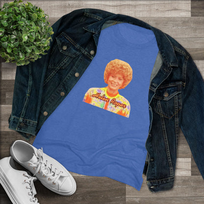 A Women's Triblend Tee by Printify, titled "Helen Roper - Three's Company," features a red design with an illustration of a smiling person with curly hair and colorful clothing. Below the illustration, the text "Helen Roper" is written in a bold, retro font, capturing the essence of vintage TV humor.