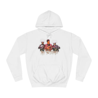 The David S Pumpkins - Any Questions? - Halloween Unisex College Hoodie by Printify is a brown sweatshirt showcasing an illustration of three people. The central figure has red hair, sports a colorful ensemble, and emanates a Halloween vibe, with two flanking figures who have white hair and wear dark attire. Beneath the trio is the phrase "Any Questions?