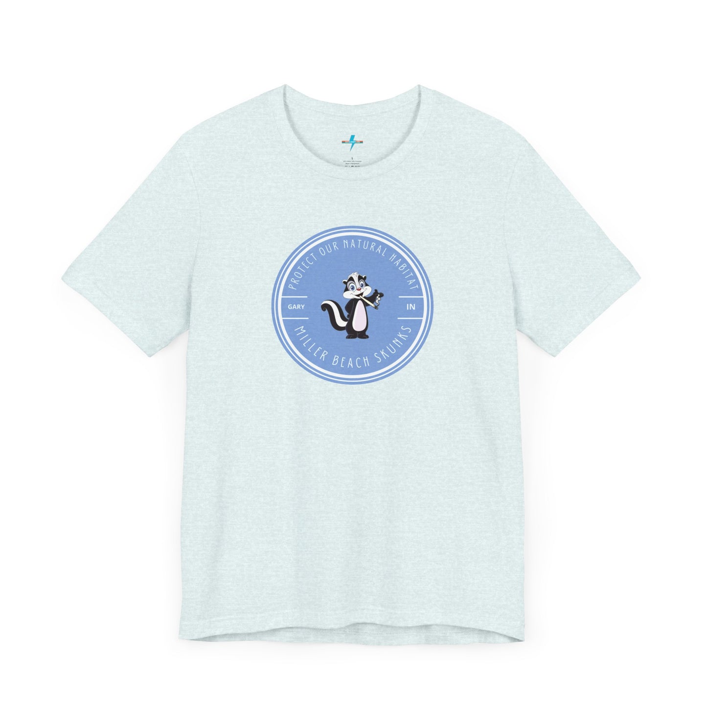 The Printify Miller Beach Skunks - Unisex Jersey Short Sleeve Tee is a gray T-shirt that features a circular blue logo at the center. Inside the logo, there is an illustration of a skunk with the text "Protect Our Habitat" and "Miller Beach Skunks" around the border, promoting environmental consciousness. The upper left part of the logo reads "Gary, IN.