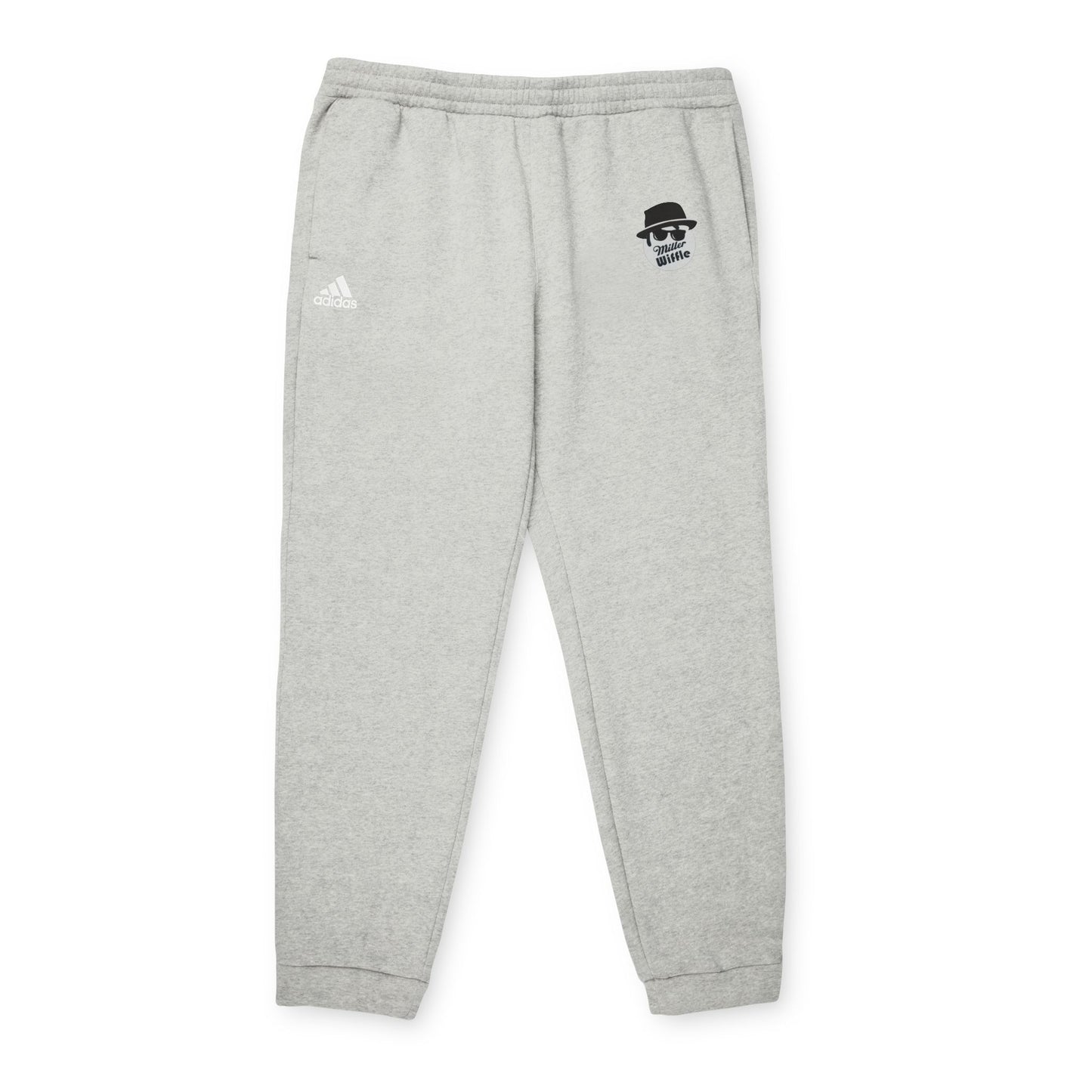 Introducing the Printify Miller Beach Wiffel Ball Blues Brothers Adidas Unisex Fleece Joggers: stylish gray sweatpants adorned with the iconic Adidas logo and a unique design of a stylized face wearing sunglasses and a hat on the left leg, crafted from sustainable materials under the Better Cotton Initiative.