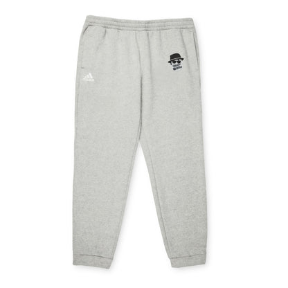 Introducing the Printify Miller Beach Wiffel Ball Blues Brothers Adidas Unisex Fleece Joggers: stylish gray sweatpants adorned with the iconic Adidas logo and a unique design of a stylized face wearing sunglasses and a hat on the left leg, crafted from sustainable materials under the Better Cotton Initiative.