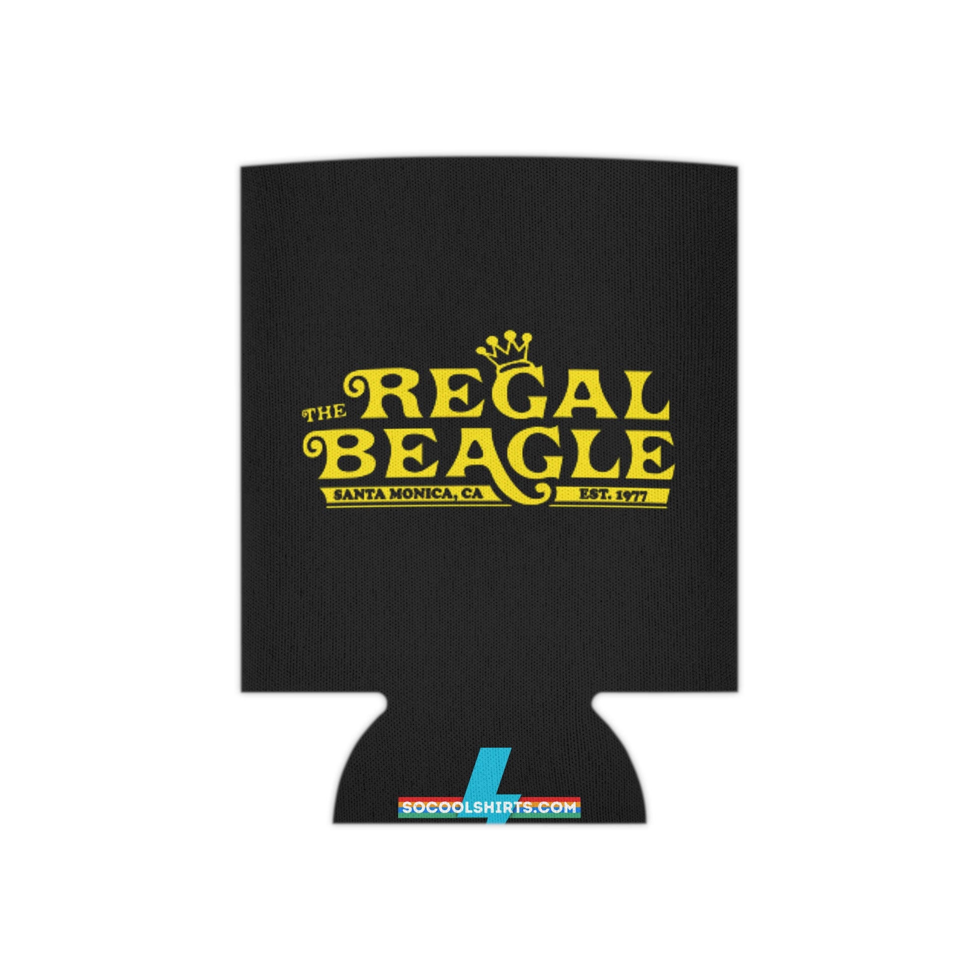 The Regal Beagle - Three's Company - Koozie by Printify features a black design with yellow text that reads "The Regal Beagle," alongside "Santa Monica, CA" and "Est. 1977." A small, partially visible URL in white and blue at the bottom reads socoolshirts.com. An ideal accessory for fans of Three’s Company!