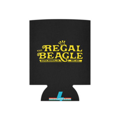 The Regal Beagle - Three's Company - Koozie by Printify features a black design with yellow text that reads "The Regal Beagle," alongside "Santa Monica, CA" and "Est. 1977." A small, partially visible URL in white and blue at the bottom reads socoolshirts.com. An ideal accessory for fans of Three’s Company!