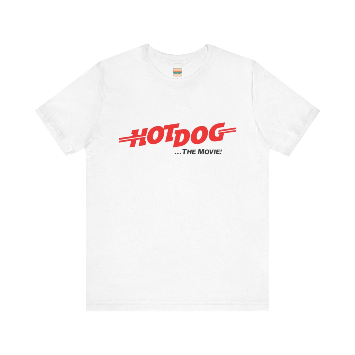 A smiling man and woman interact while wearing matching yellow "Hot Dog The Movie 1984 - Unisex Jersey Short Sleeve Tee" by Printify, featuring bold red "HOT DOG THE MOVIE" text. Their vibrant tees perfectly complement their blue jeans, with the man casually having his hands in his pockets and the woman resting one hand on his shoulder.