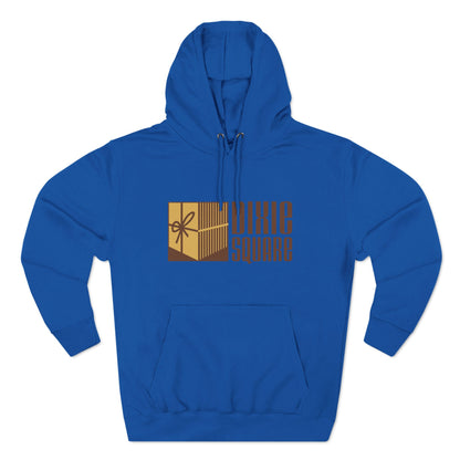 A black hoodie from Printify, named "Dixie Square 1960s Logo - Harvey, IL - Three-Panel Fleece Hoodie," featuring the words "Dixie Square" in brown stylized block letters on the front. Embracing a retro charm, the design also includes a graphic of a gold-colored square with a scissors icon and vertical lines, reminiscent of Dixie Square Mall's heyday.