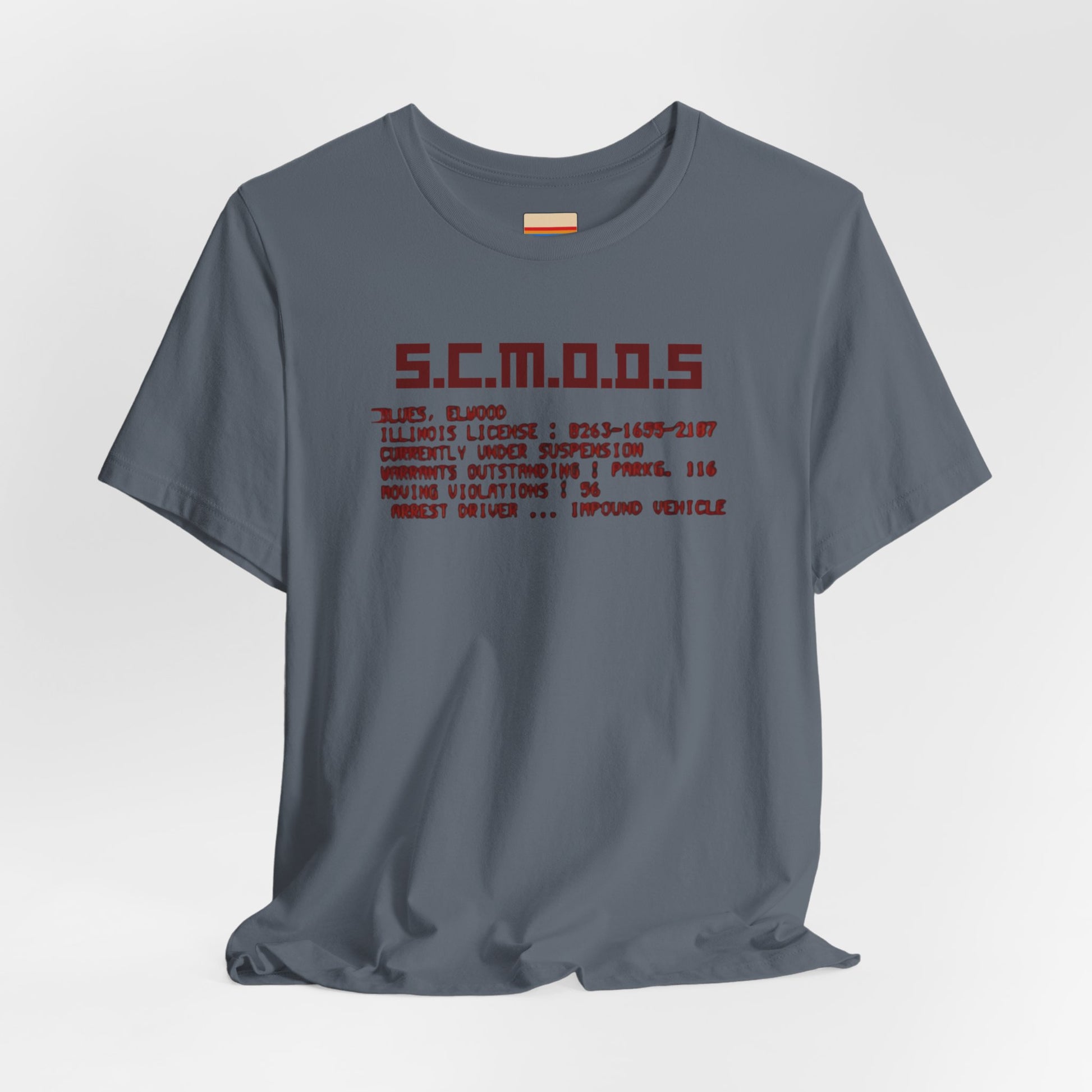 Two yellow "S.C.M.O.D.S. Blues Brother's - Unisex Jersey Short Sleeve Tee" shirts from Printify, featuring "S.C.M.O.D.S" in bold, stylized letters along with smaller text detailing terms like "Illinois," "license," and "impound vehicle." Perfect for fans of The Blues Brothers and Jake and Elwood Blues, the T-shirts are neatly folded and stacked.