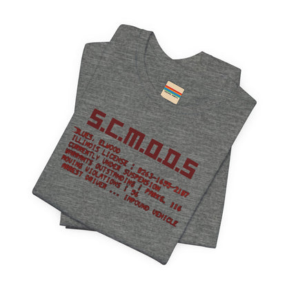 Two yellow "S.C.M.O.D.S. Blues Brother's - Unisex Jersey Short Sleeve Tee" shirts from Printify, featuring "S.C.M.O.D.S" in bold, stylized letters along with smaller text detailing terms like "Illinois," "license," and "impound vehicle." Perfect for fans of The Blues Brothers and Jake and Elwood Blues, the T-shirts are neatly folded and stacked.