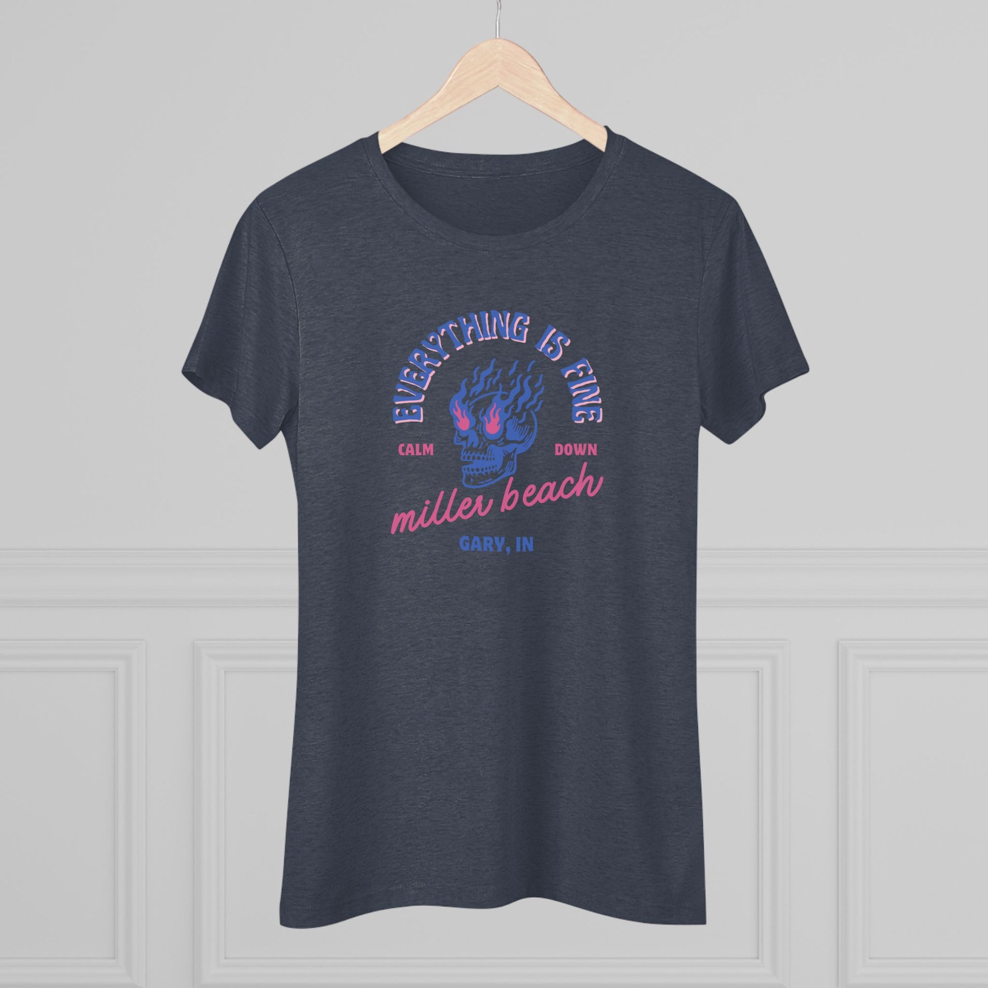 Introducing the Miller Beach - Everything is Fine - Calm Down Women's Triblend Tee by Printify – a dark gray, relaxed-fit shirt adorned with a neon blue and pink flaming skull at its center. Above the skull, the text reads "Everything is Fine" and "Calm Down," while below it says "Miller Beach, Gary, IN" in a stylish script font. This tee captures a cool vintage aesthetic perfect for casual wear.