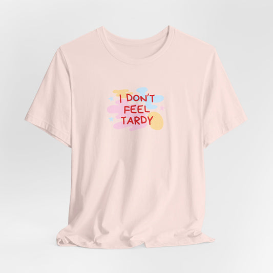 The "I Don't Feel Tardy - 1980s Retro - Unisex Jersey Short Sleeve Tee" from Printify is a light pink jersey shirt that features the bold, colorful text "I DON'T FEEL TARDY" prominently at its center. This design exudes retro vibes with small star shapes and abstract splashes of blue, yellow, and pink, laid flat against a plain background to channel pure Van Halen T-shirt energy.