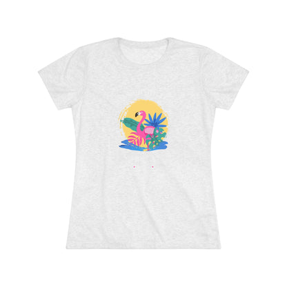 A women's triblend tee from Printify, the Miller Beach Flamingo features a blue color and "Miller Beach Gary, IN 46403" text with a vibrant design of a flamingo amidst tropical foliage for a vintage aesthetic. This t-shirt is showcased on a wooden surface alongside a denim jacket, white sneakers, and a potted plant.