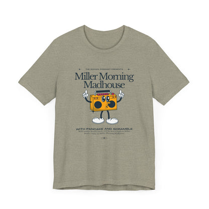 This Printify unisex jersey short sleeve tee in Sand Dune features a playful boombox cartoon character with arms, legs, and sunglasses. Emblazoned with "Miller Morning Madhouse," it highlights podcast details from "The School Podcast Presents.