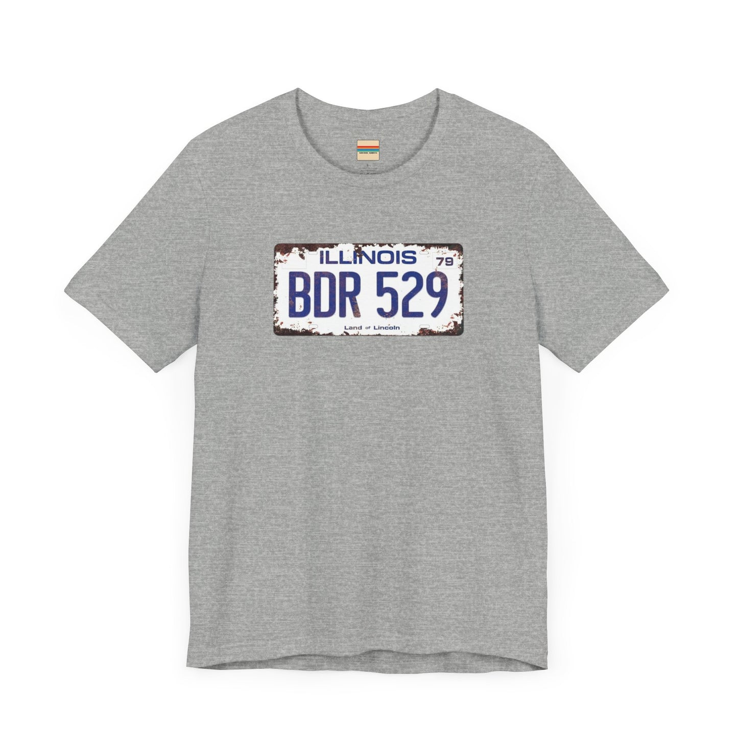 The Printify Blues Brothers BDR 529 License Plate Unisex Jersey Short Sleeve Tee showcases a vintage Illinois license plate graphic with "BDR 529" prominently displayed, as famously seen in the Blues Brothers film. The design includes "Illinois" and "Land of Lincoln" above and below the numbers, with a weathered, rustic look that enhances its retro appeal.