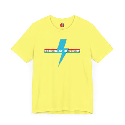 This unisex jersey short sleeve tee by Printify features a striking maroon color with a central light blue lightning bolt design. The text "SOCOOLSHIRTS.COM" is prominently displayed across the lightning bolt in white letters, set against a multicolored background that exudes retro vibes. The shirt is shown laid flat on a white backdrop.