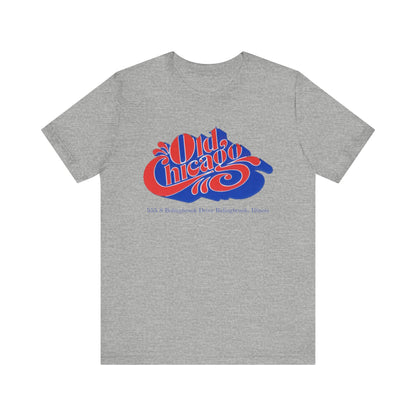 The "Old Chicago Mall Bolingbrook 1980s Retro - Unisex Jersey Short Sleeve Tee" from Printify is a gray T-shirt showcasing a vintage design with the text "Old Chicago" in blue and red. Beneath the main text, the address "355 S. Bolingbrook Drive, Bolingbrook, Illinois" appears in smaller font, evoking 80s nostalgia of the Old Chicago Mall. The shirt is displayed against a white background.