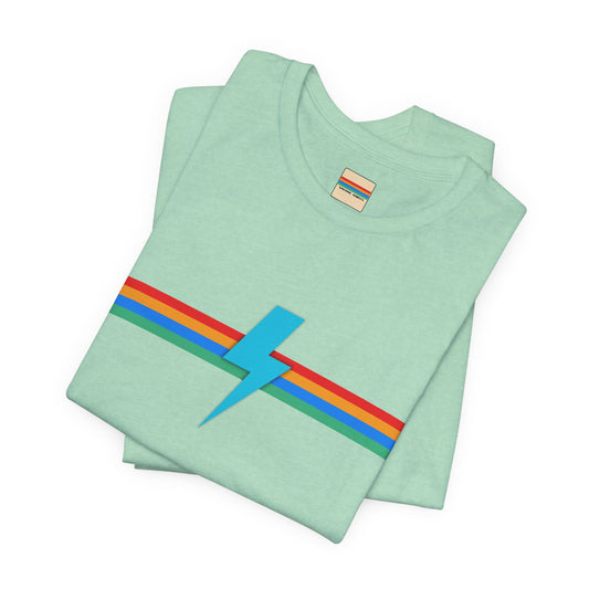 A neatly folded light green "SoCool Shirts OG Logo Retro - Unisex Jersey Short Sleeve Tee" from Printify, featuring a colorful horizontal stripe design across the chest in blue, red, green, and yellow with an original lightning bolt logo in the middle.